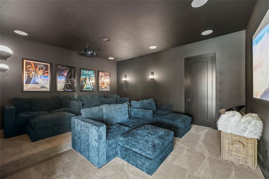 Now into the downstairs media room. You will love the details, including the top of the line projector and surround sound speaker system. Pop some popcorn, whether it's movie night or game night this space is the perfect space to enjoy just being with family.