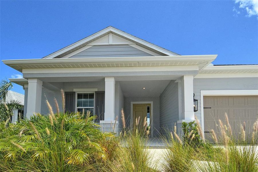 Front exterior of a new home in Canoe Creek, Parrish, FL, highlighting curb appeal (Image 21).