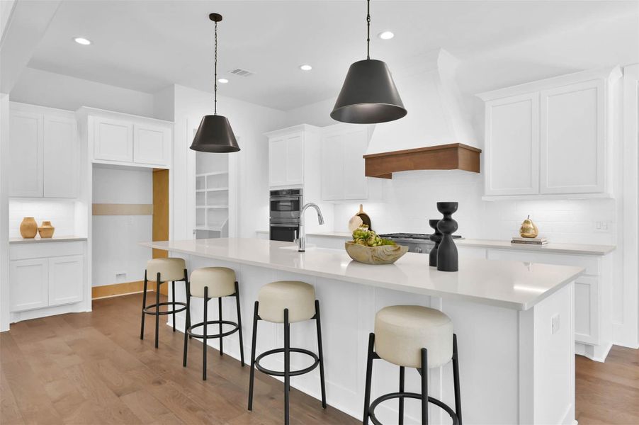Satin black pendants are the perfect modern choice in this kitchen. Satin black pendants are the perfect modern choice in this kitchen.