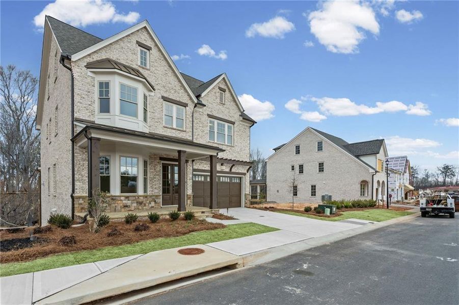 Front exterior of a new home in Laurel View, Suwanee, GA, highlighting curb appeal (Image 29). Front exterior of a new home in Laurel View, Suwanee, GA, highlighting curb appeal (Image 29).