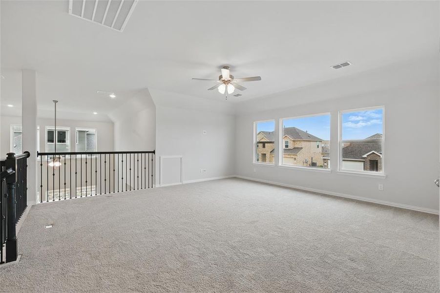 Carpeted spare room featuring ceiling fan, baseboards, and recessed lighting Carpeted spare room featuring ceiling fan, baseboards, and recessed lighting