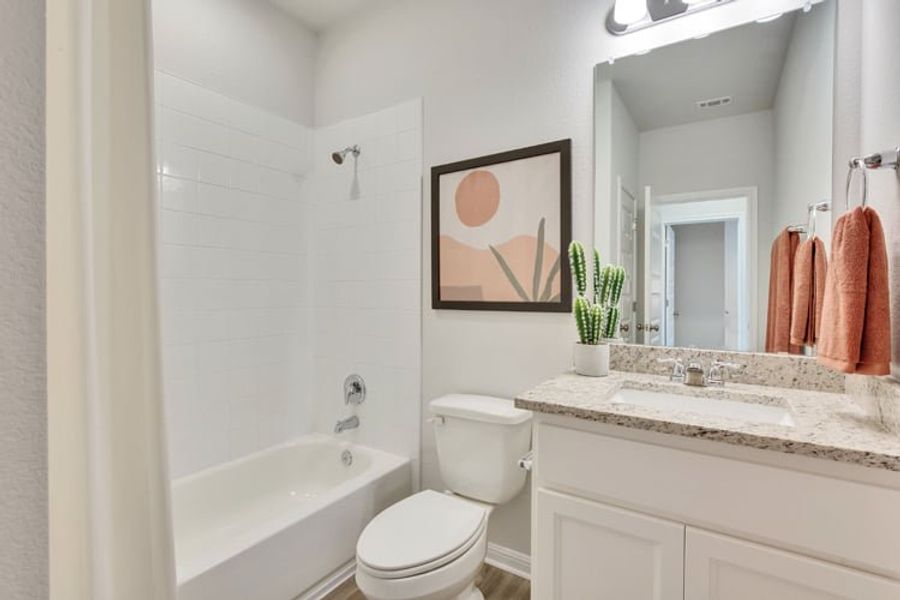 A bathroom with a sink toilet and bathtub. A bathroom with a sink toilet and bathtub.