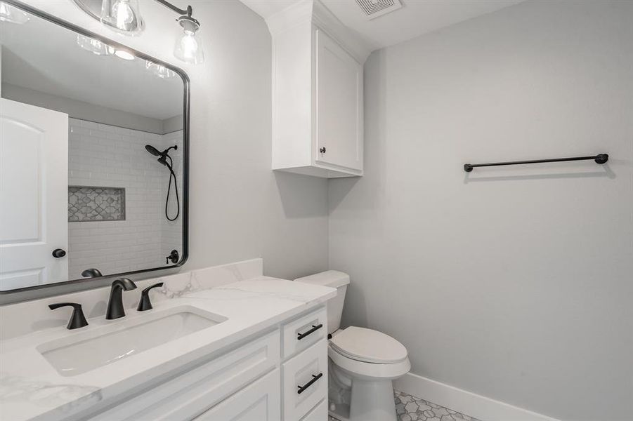 Bathroom featuring tile patterned floors, vanity, and toilet