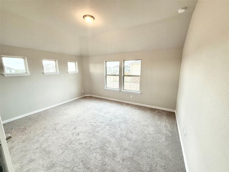 Spare room with carpet flooring and vaulted ceiling Spare room with carpet flooring and vaulted ceiling