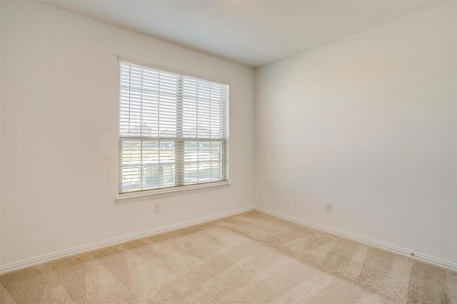 Unfurnished room featuring light carpet