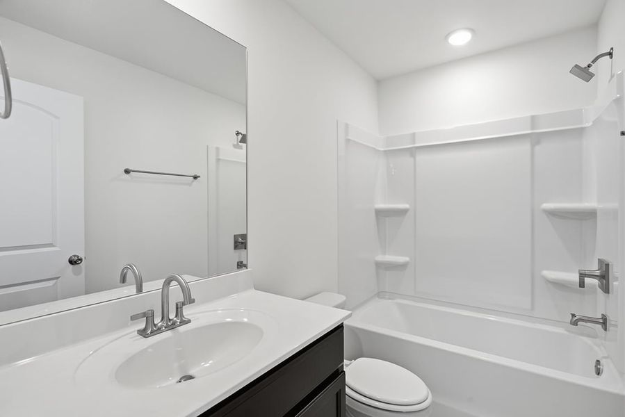 A bathroom with a tub sink and toilet. A bathroom with a tub sink and toilet.