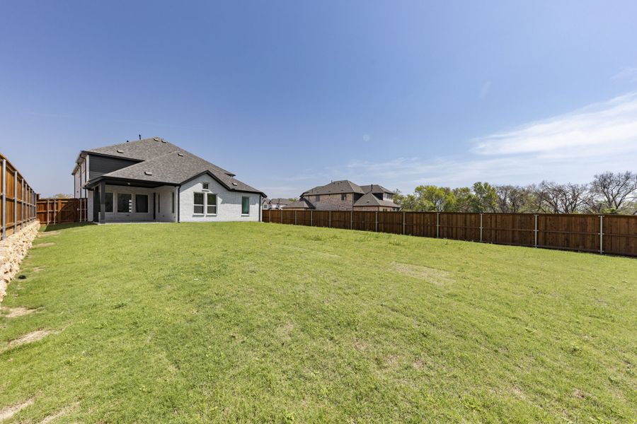 Exterior details and patio area of a home in The Reserve at Spiritas Ranch, Little Elm (Image 26). Exterior details and patio area of a home in The Reserve at Spiritas Ranch, Little Elm (Image 26).