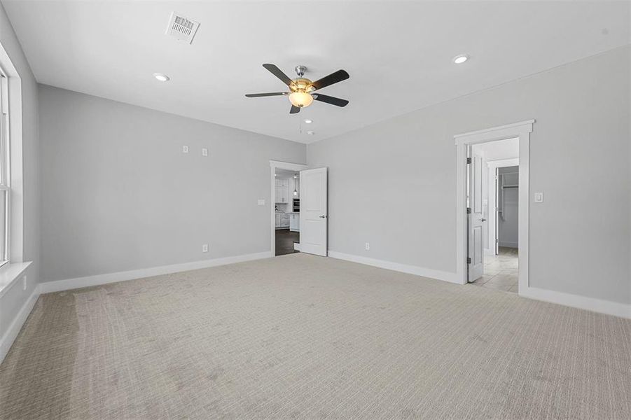 Unfurnished room with light carpet and ceiling fan