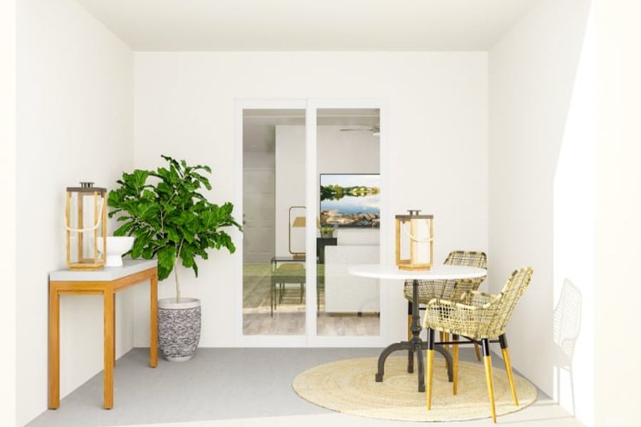 A room with a table chairs and a plant in it.