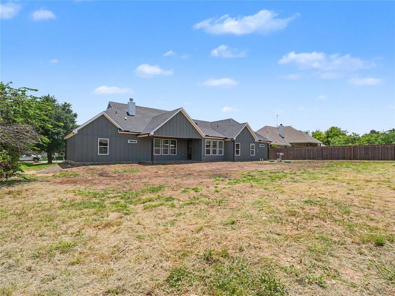 Contemporary single-story residence with gray siding and a dark shingled roof Contemporary single-story residence with gray siding and a dark shingled roof
