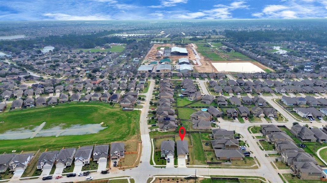 An aerial view of a spacious subdivision lot, highlighting a well-maintained yard and a fully fenced perimeter, offering both privacy and expansive outdoor space.