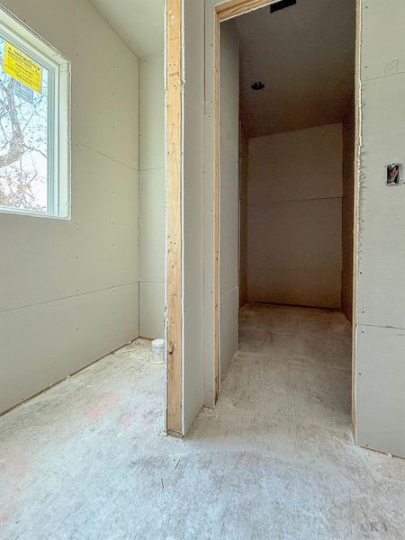 ***Estimated completion April 15, 2026. Showings by appointment only and must be accompanied due to active construction.*** Second primary bedroom closet located within the bathroom. ***Estimated completion April 15, 2026. Showings by appointment only and must be accompanied due to active construction.*** Second primary bedroom closet located within the bathroom.