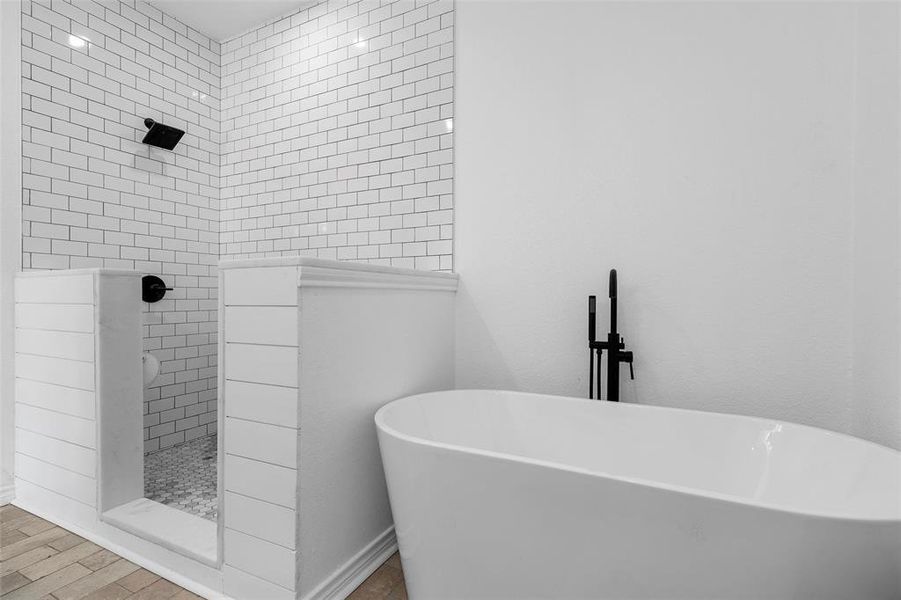 Full bath with walk in shower and a soaking tub