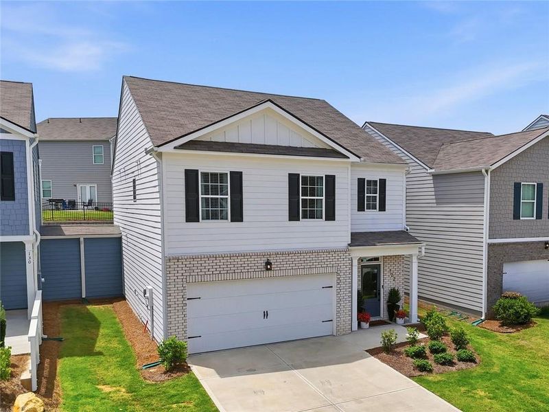 Front exterior of a new home in Rolling Meadows, Jasper, GA, highlighting curb appeal (Image 2). Front exterior of a new home in Rolling Meadows, Jasper, GA, highlighting curb appeal (Image 2).