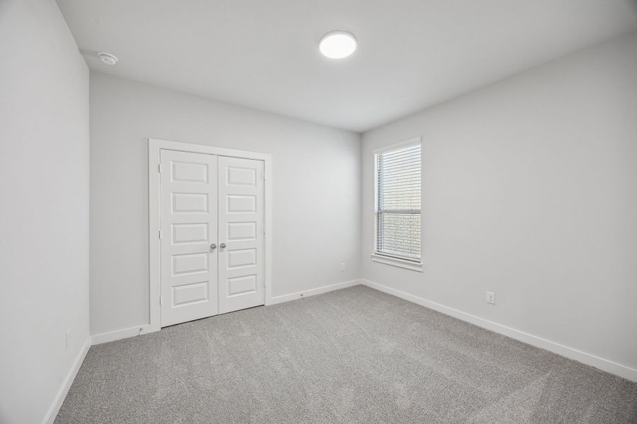 Bedroom in the Wimbledon home plan by Trophy Signature Homes – REPRESENTATIVE PHOTO