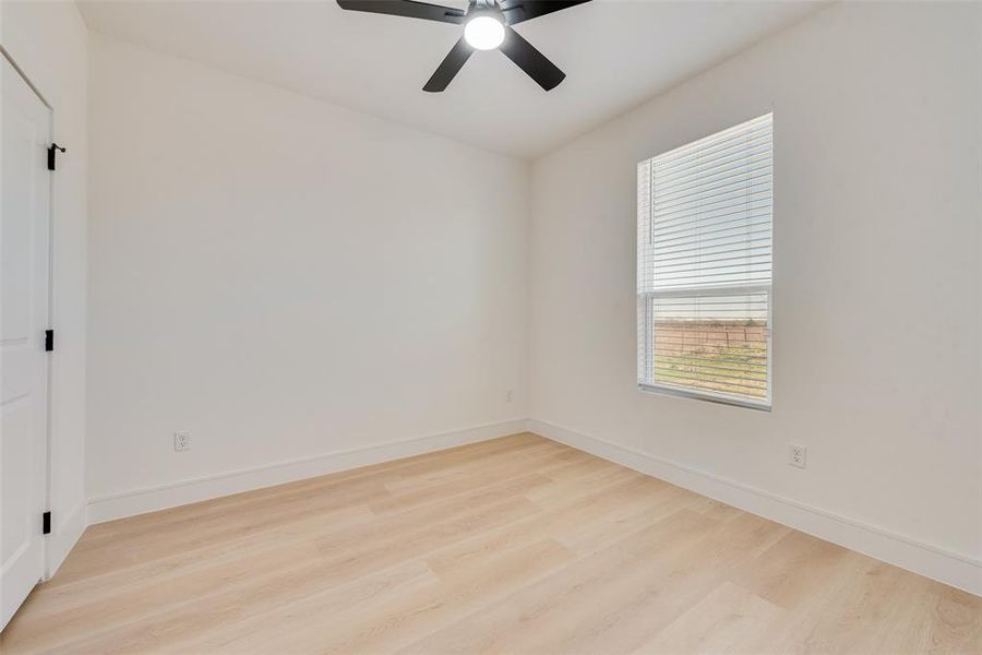 Unfurnished room featuring light hardwood / wood-style floors and ceiling fan