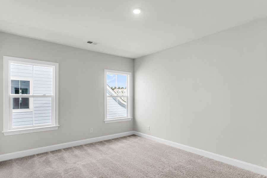 Spacious, unfurnished interior of a new home in Tidewater at Lakes of Cane Bay, Summerville (Image 51).