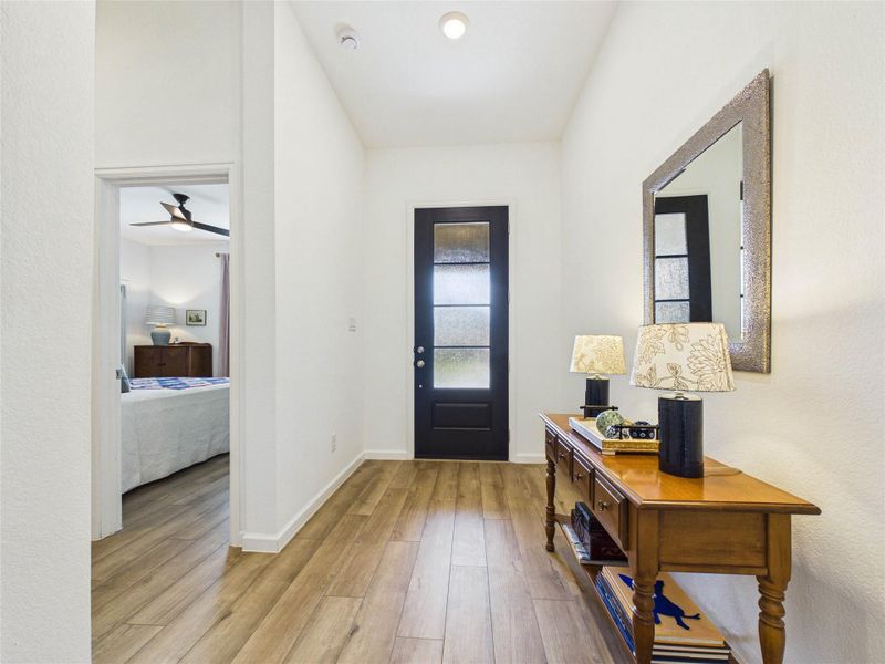Looking towards the beautiful front door you have your hallway with 2 secondary bedrooms and a full sized bathroom on your left.