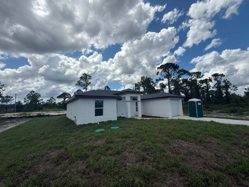 Front exterior of a new home in , Lehigh Acres, FL, highlighting curb appeal (Image 2). Front exterior of a new home in , Lehigh Acres, FL, highlighting curb appeal (Image 2).