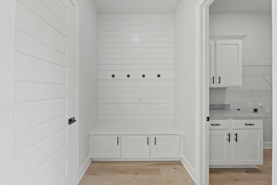 Mudroom and laundry room are conveniently adjacent as you enter from the garage.