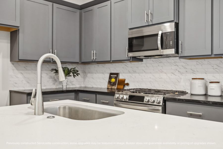 Sleek and Functional. This chef-inspired kitchen features a spacious island, quartz countertops, and custom cabinetry, perfect for effortless entertaining.