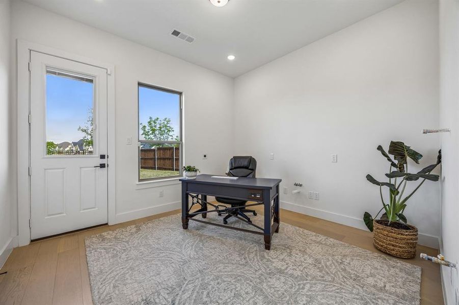 Second kitchen that is full piped that is used as an Office area featuring light wood-style flooring and recessed lighting