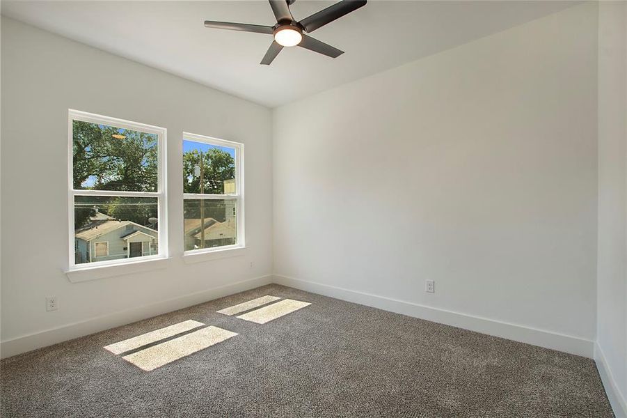 Unfurnished room with carpet and ceiling fan