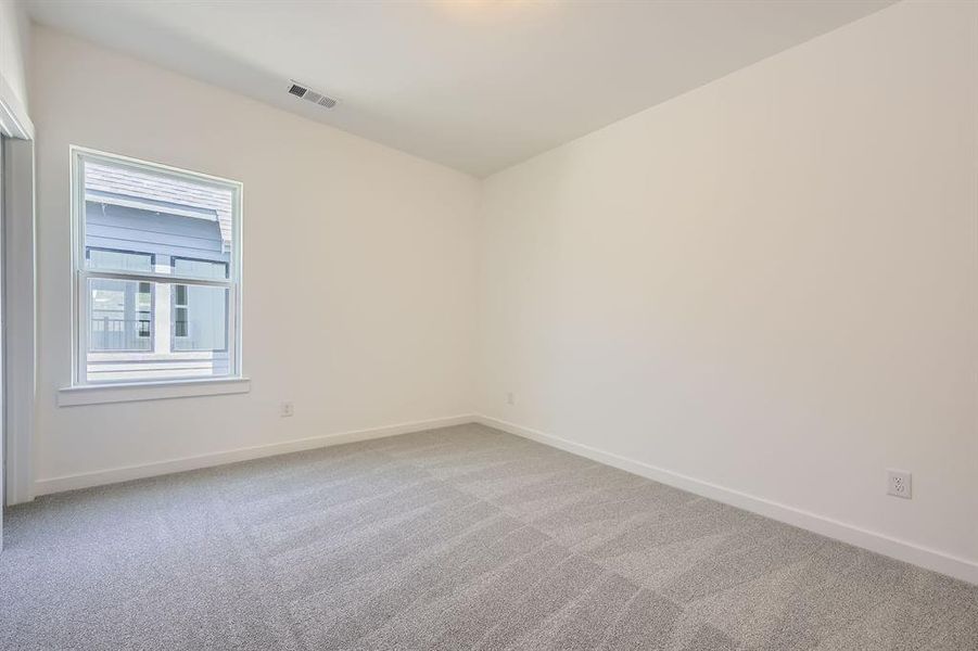 Carpeted empty room with baseboards Carpeted empty room with baseboards