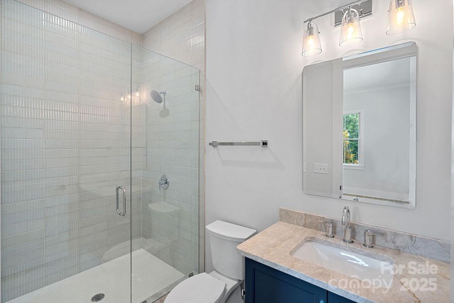 Ensuite bathroom for Bedroom #2. I love the tile in this home!