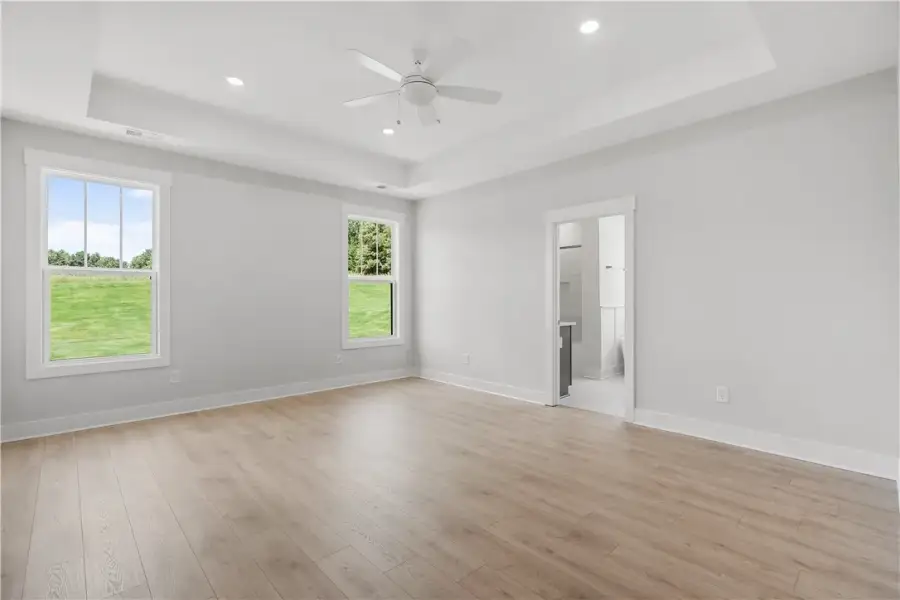 Recessed lighting and a ceiling fan illuminate thi Recessed lighting and a ceiling fan illuminate thi