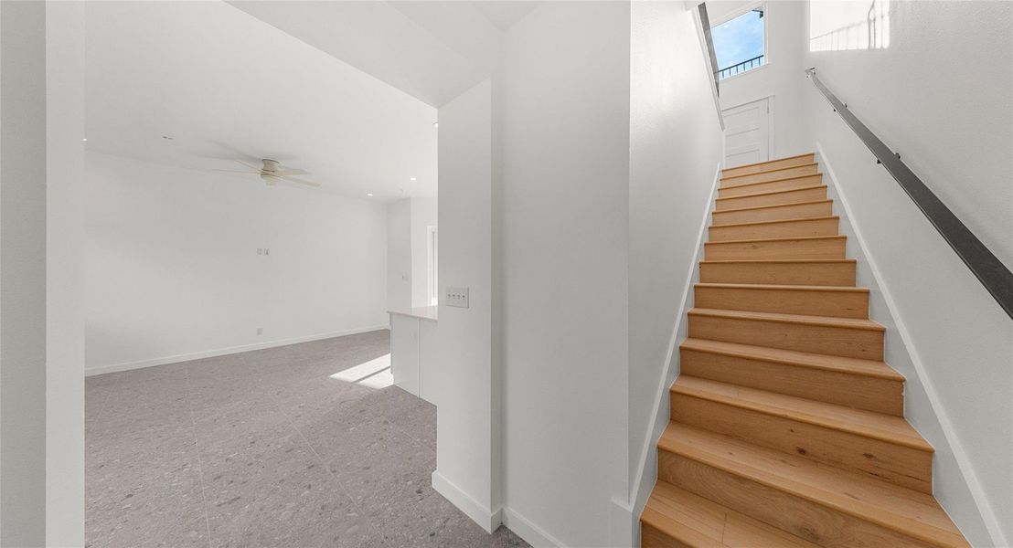 A sculptural staircase with warm wood treads — a design moment that elevates the everyday. Model No. 104 Shown.