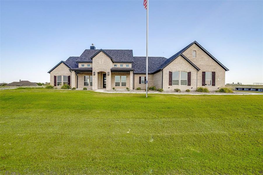 Front exterior of a new home in Rocky Top Ranch, Reno, TX, highlighting curb appeal (Image 21). Front exterior of a new home in Rocky Top Ranch, Reno, TX, highlighting curb appeal (Image 21).