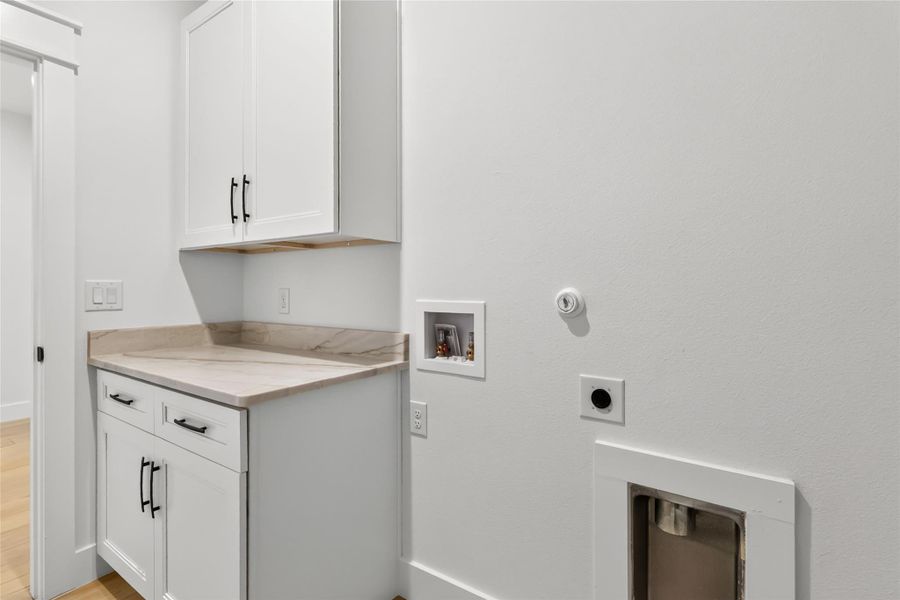 Laundry room w/ cabinets and granite countertop