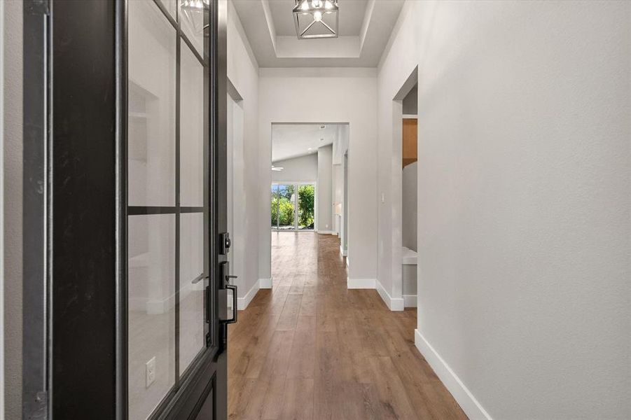 Hall featuring light wood-type flooring and baseboards Hall featuring light wood-type flooring and baseboards
