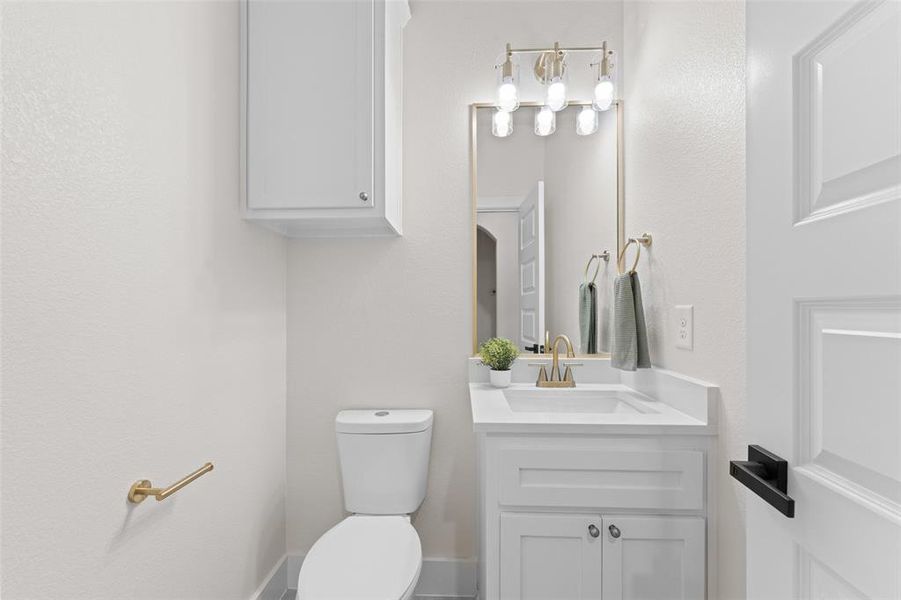 Half bath with toilet and vanity Half bath with toilet and vanity