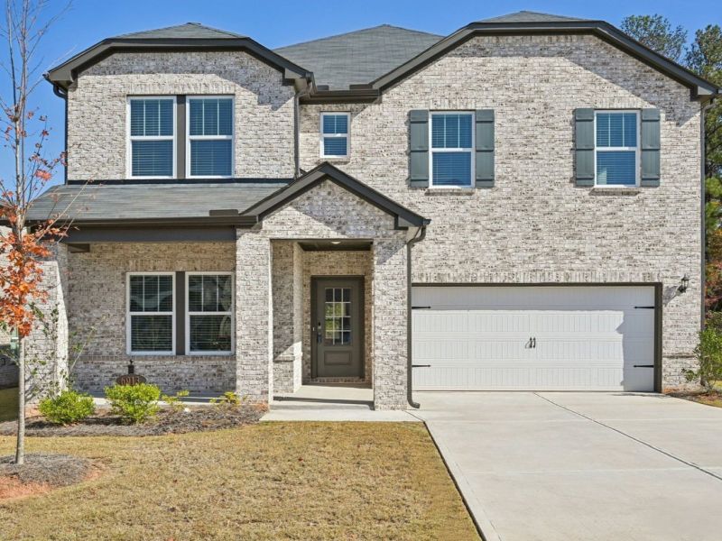Front exterior of a new home in Creekside at Oxford Park, Fairburn, GA, highlighting curb appeal (Image 1).