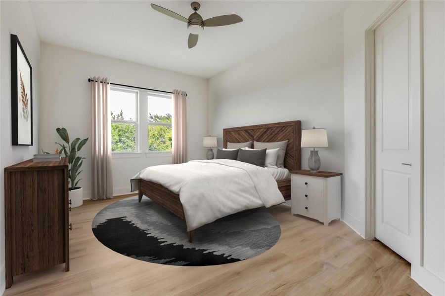 Bedroom with light wood-style flooring and a ceiling fan