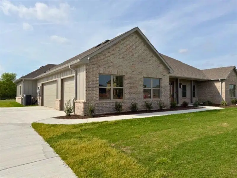 Front exterior of a new home in , Sanger, TX, highlighting curb appeal (Image 20).