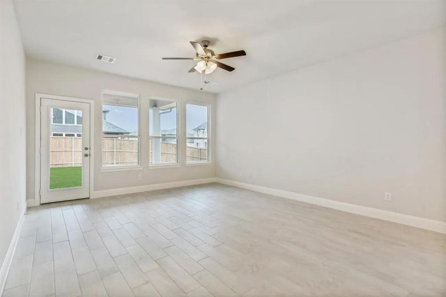 Unfurnished room with light wood-type flooring and ceiling fan