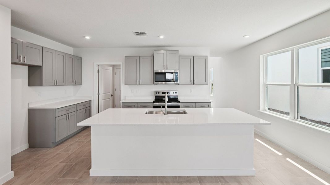 Kitchen and Island of the Jupiter in Hamilton Bluff located in Haines City, FL.