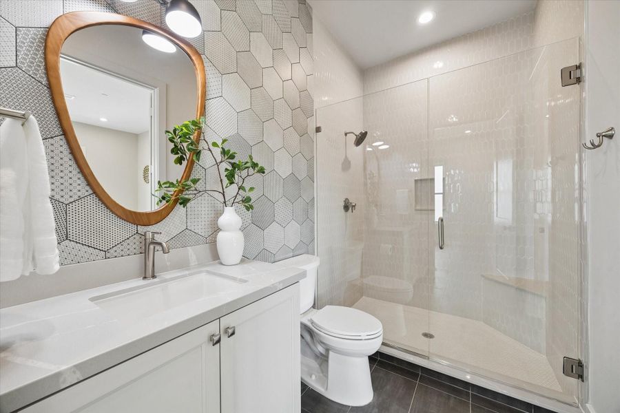 The guest bath off the game room features an oversized shower, offering comfort and convenience for the adjacent guest bedroom and upstairs living area. The guest bath off the game room features an oversized shower, offering comfort and convenience for the adjacent guest bedroom and upstairs living area.
