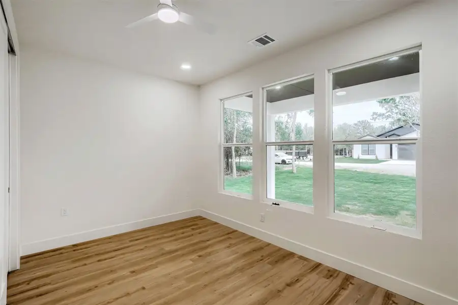 Bright and versatile bedroom with large windows and abundant natural light