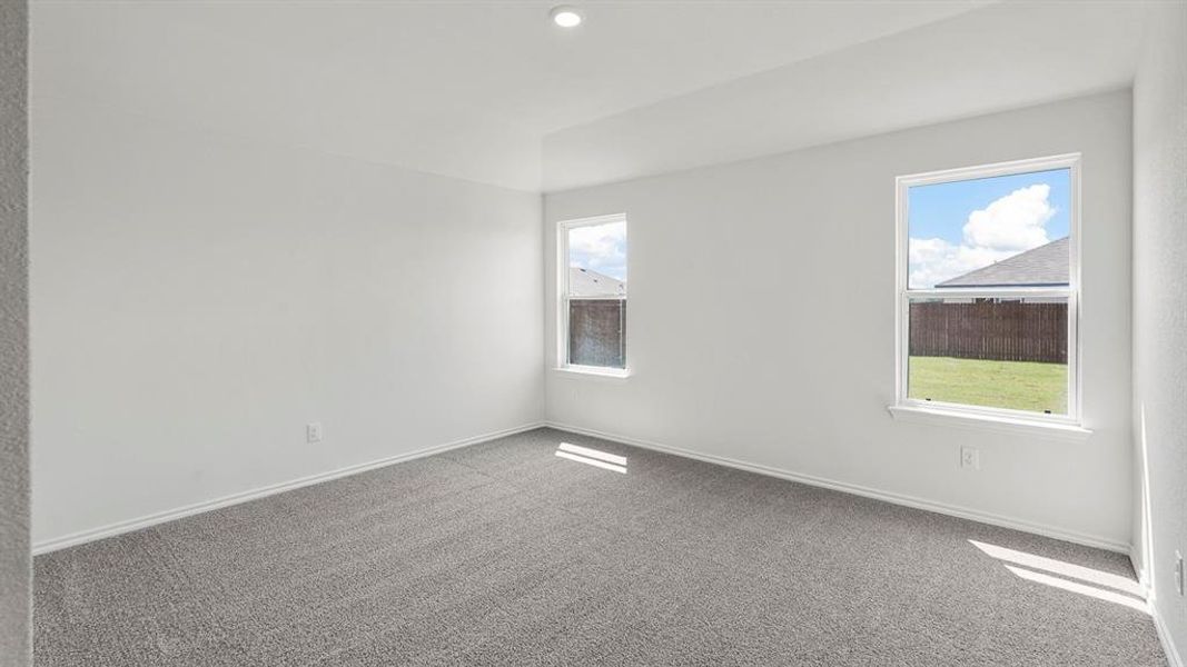 Spacious room featuring neutral carpeting and white painted walls