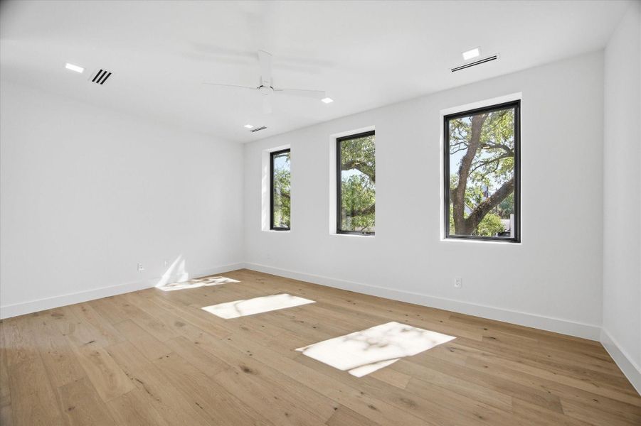 Large windows frame treetop views, bringing in soft natural light and a sense of openness.