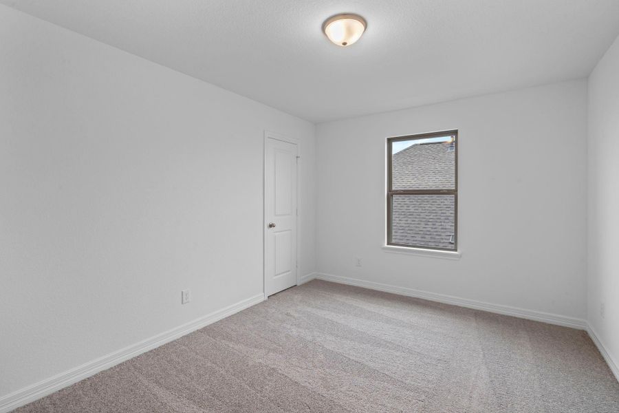 Your secondary bedroom features plush carpet, fresh paint, closet, and a large window that lets in plenty of natural lighting.