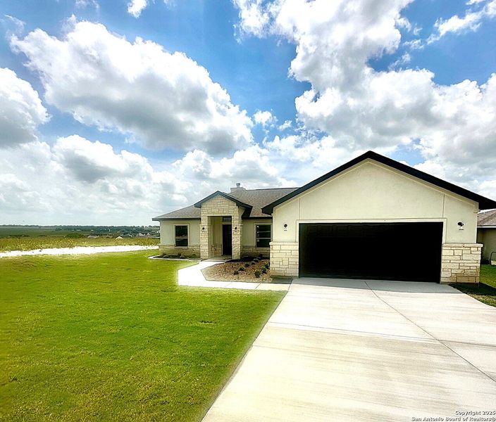 Front exterior of a new home in , La Vernia, TX, highlighting curb appeal (Image 29). Front exterior of a new home in , La Vernia, TX, highlighting curb appeal (Image 29).
