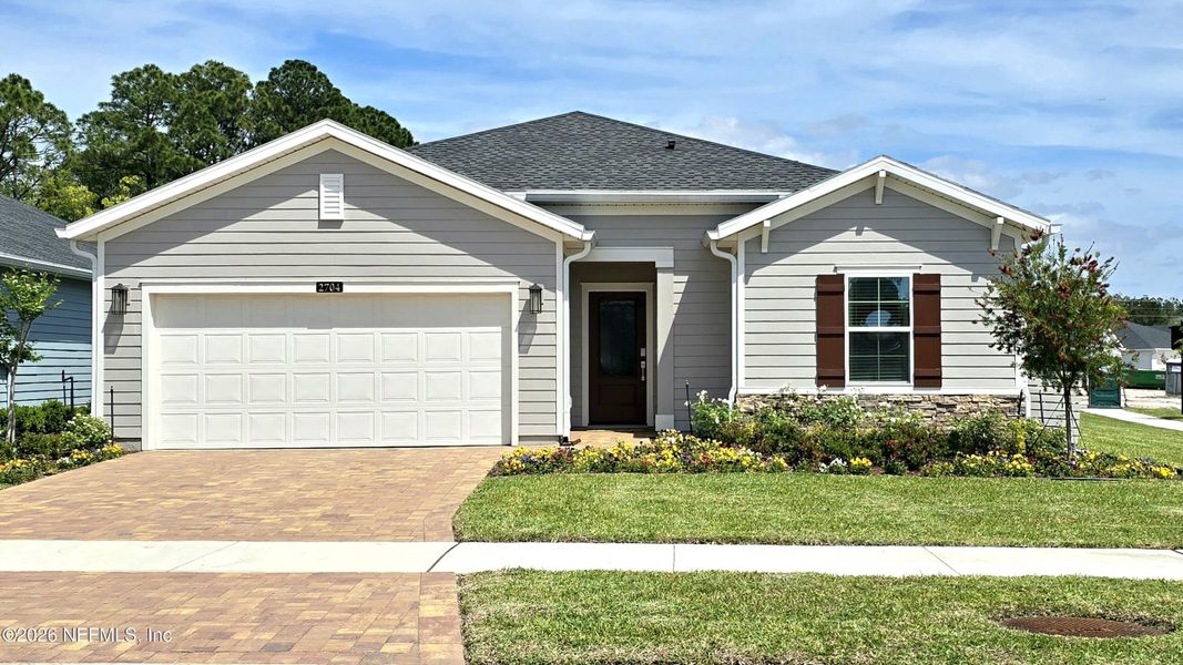 Front exterior of a new home in Edenbrooke at Hyland Trail | 55+, Green Cove Springs, FL, highlighting curb appeal (Image 2).