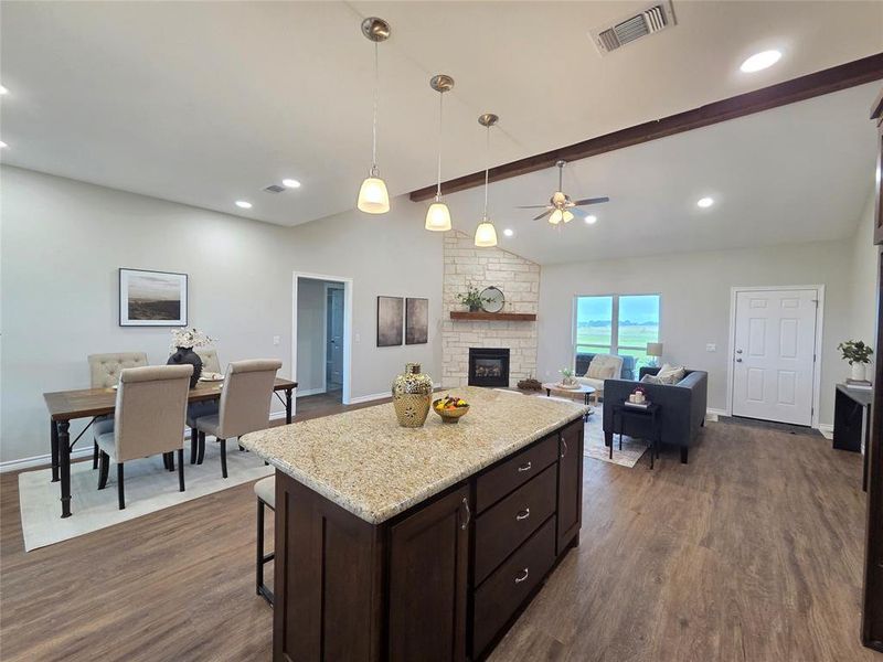 Kitchen with dark wood finished floors, ceiling fan, a fireplace, dark brown cabinetry, and recessed lighting Kitchen with dark wood finished floors, ceiling fan, a fireplace, dark brown cabinetry, and recessed lighting