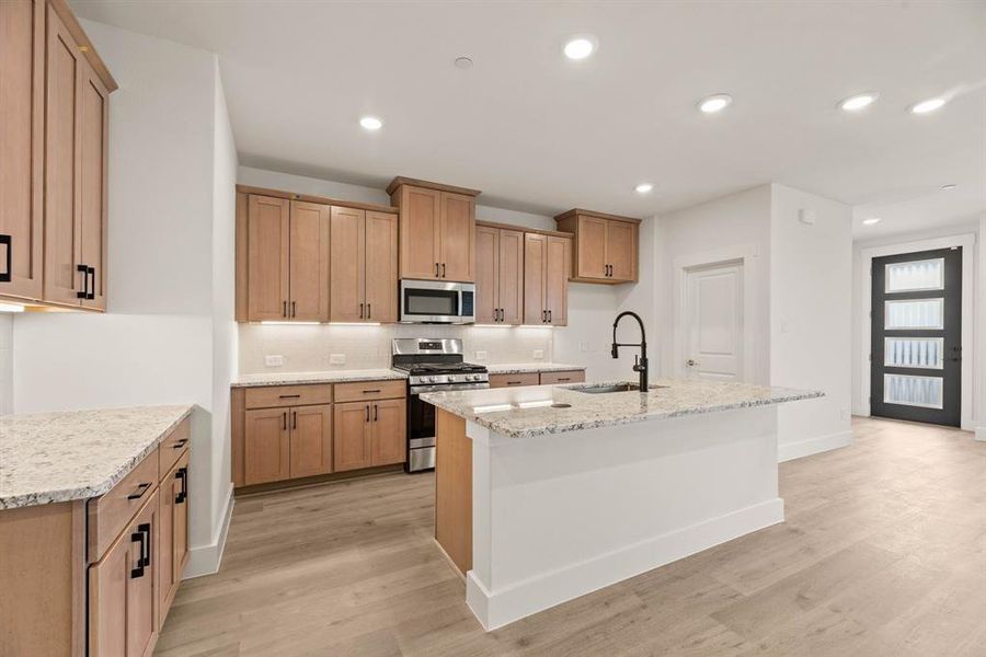 This dream kitchen features wood tone cabinets that blend perfectly with the neutral flooring and beautiful counter tops. This dream kitchen features wood tone cabinets that blend perfectly with the neutral flooring and beautiful counter tops.
