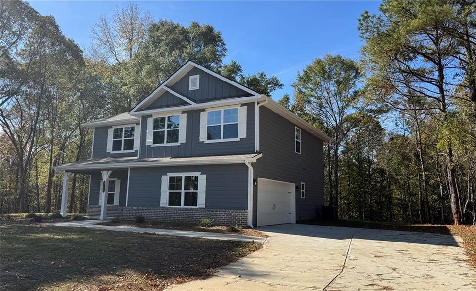 Front exterior of a new home in The Fields of Walnut Creek, Pendergrass, GA, highlighting curb appeal (Image 12).